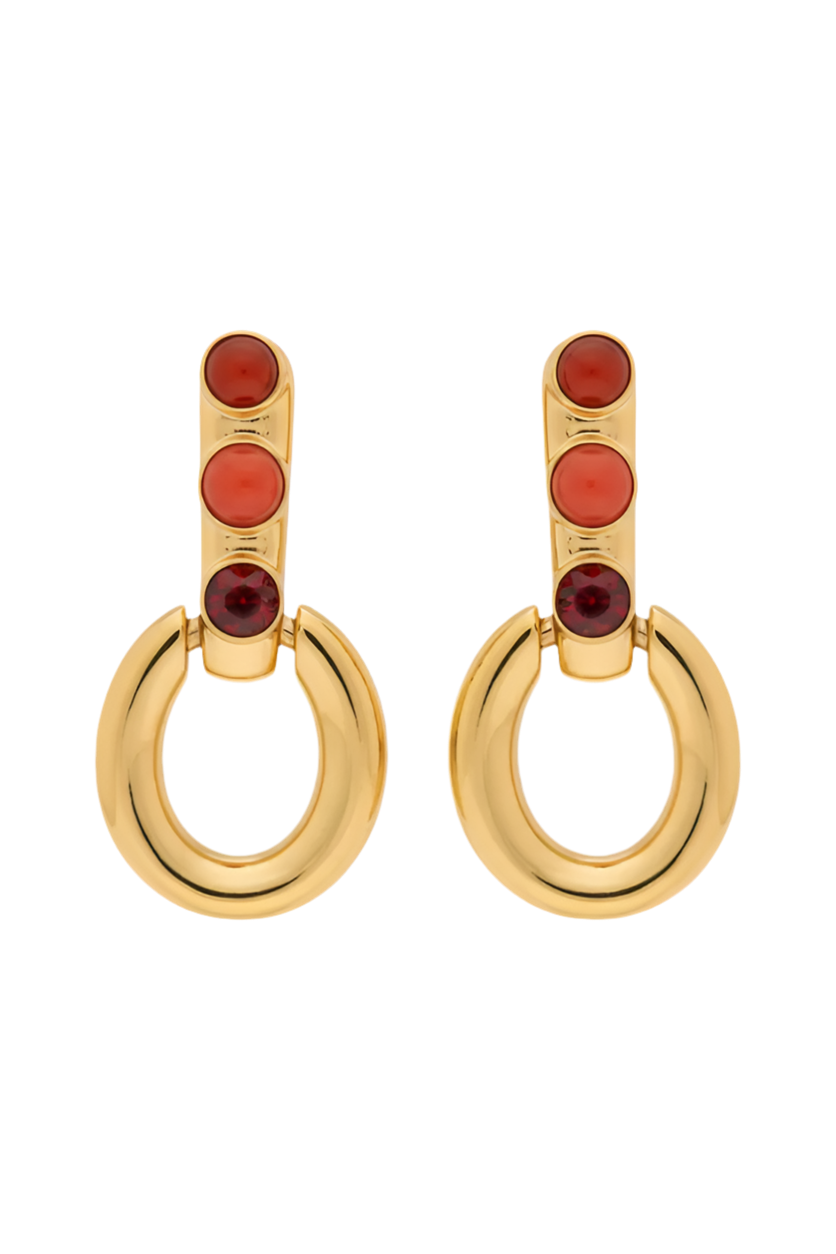 Gold hoop earrings with red stones on a white background