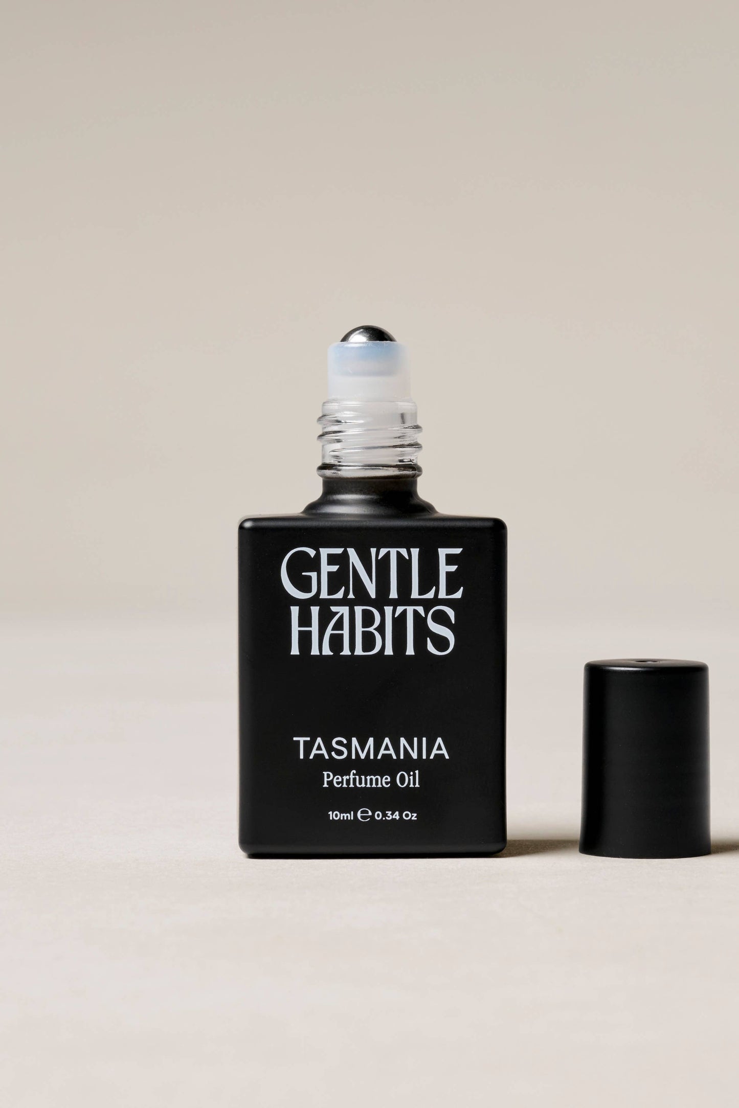Gentle Habits Tasmania perfume oil bottle on a beige background
