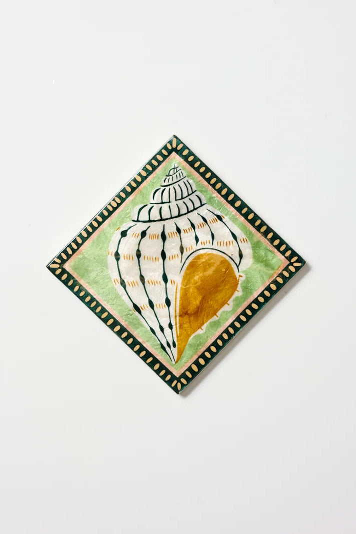Decorative tile with shell design on a white background