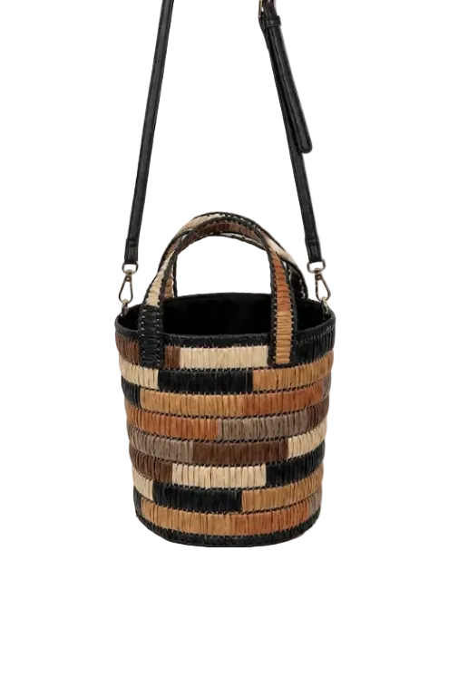 A woven bucket-style shoulder bag with a black leather strap and handles, featuring horizontal stripes of black, tan, and brown raffia on a white background.
