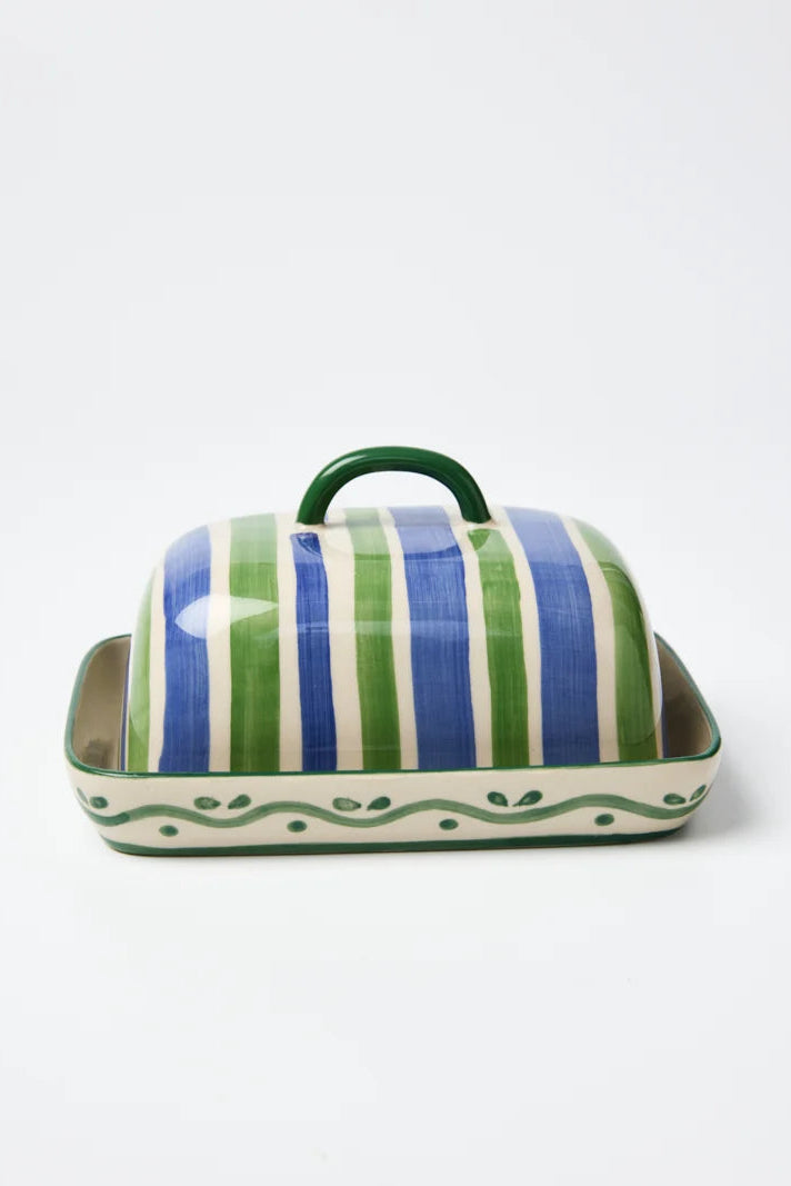 Ceramic butter dish with striped lid on a white background
