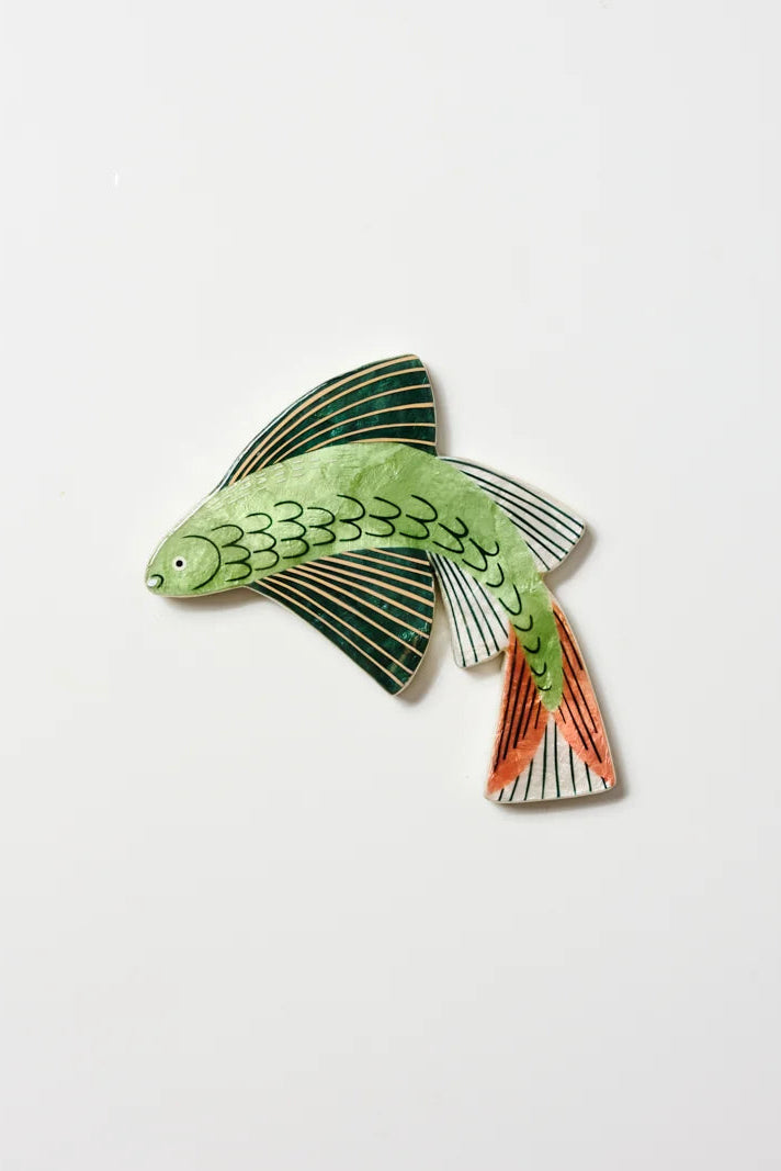 A decorative fish-shaped wall hanging or ornament with a light green body, dark green striped fins, and orange-red tail details, shown against a plain white background.