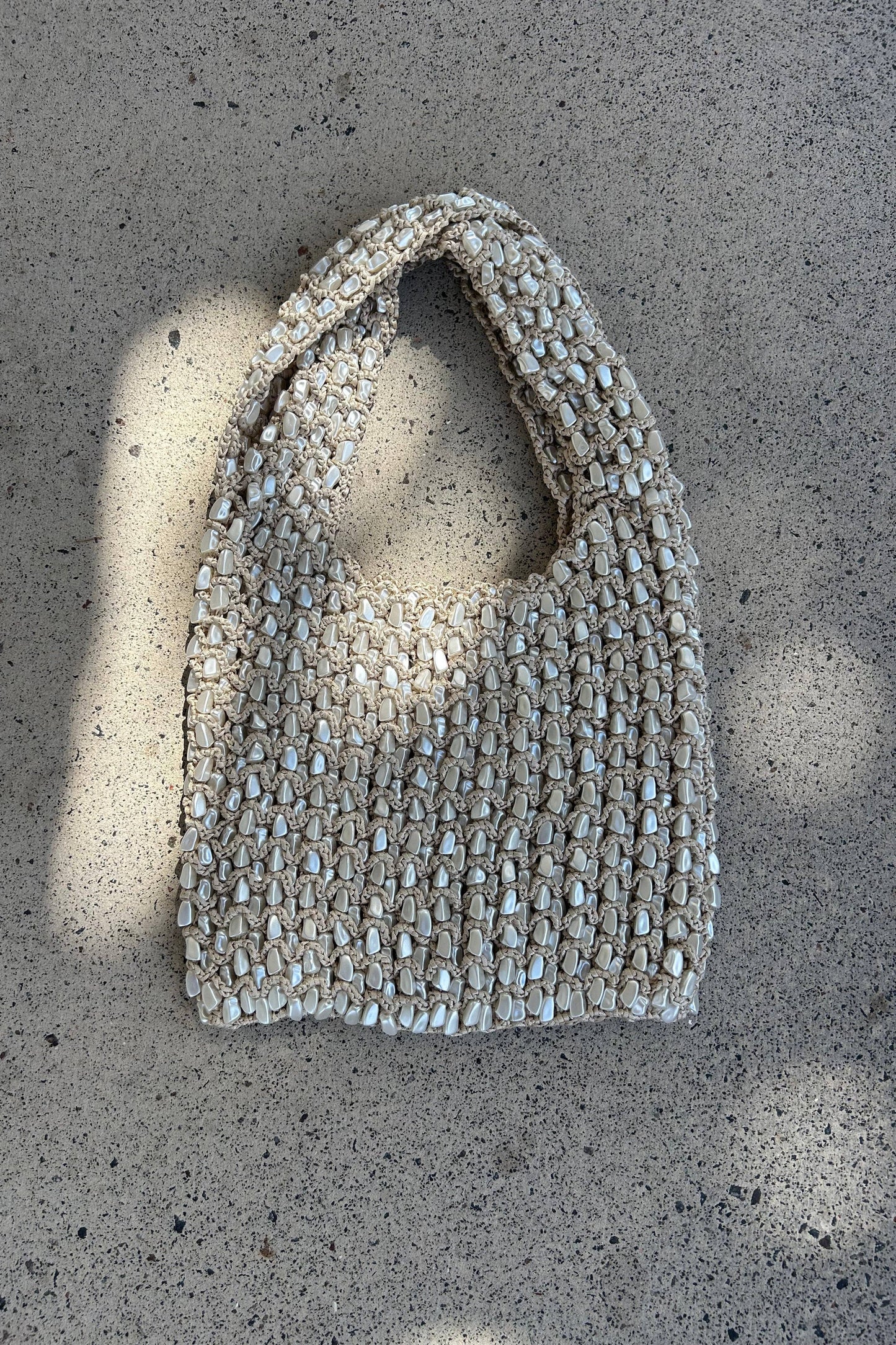Textured handbag on a concrete surface