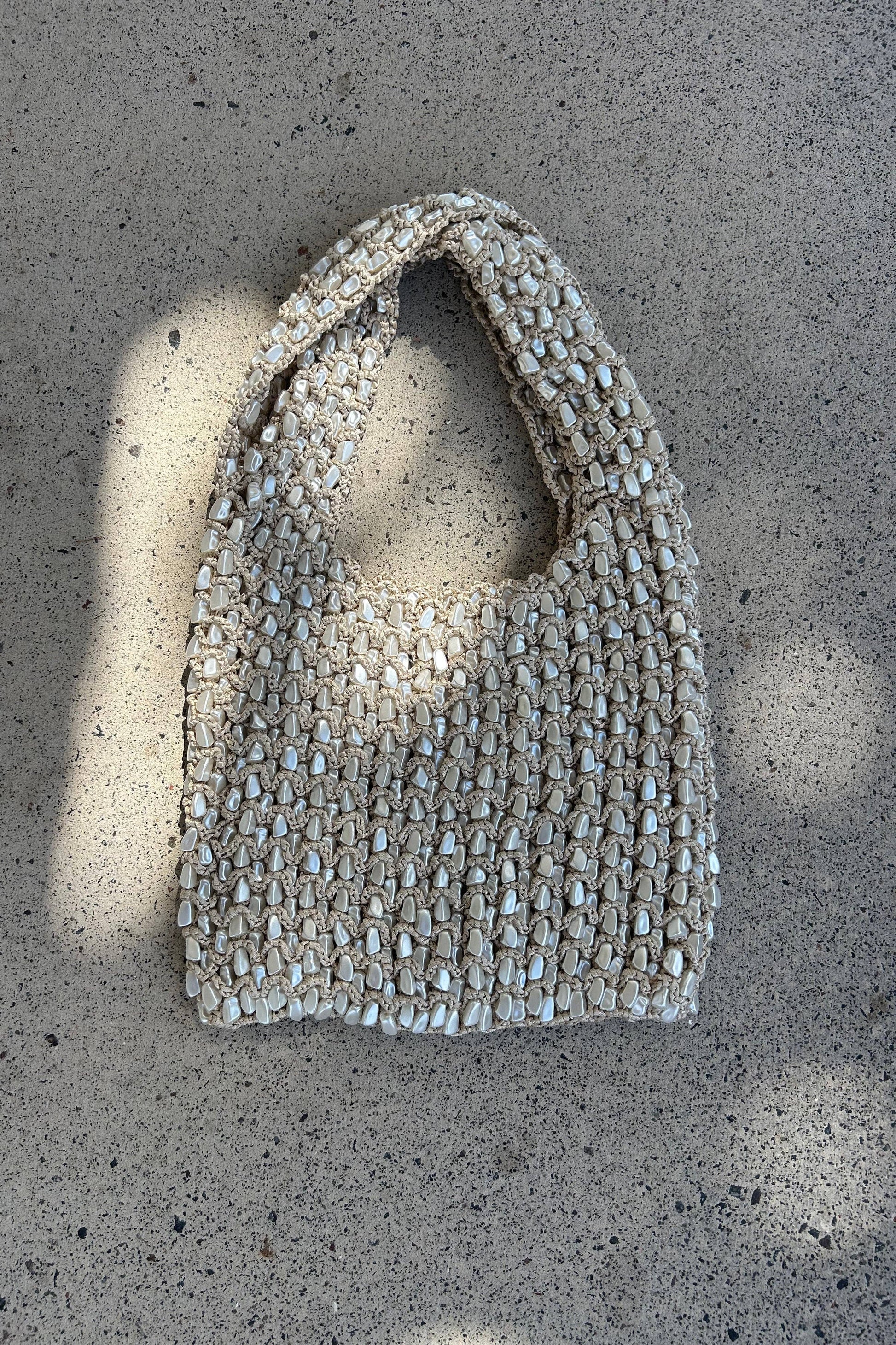 Textured handbag on a concrete surface