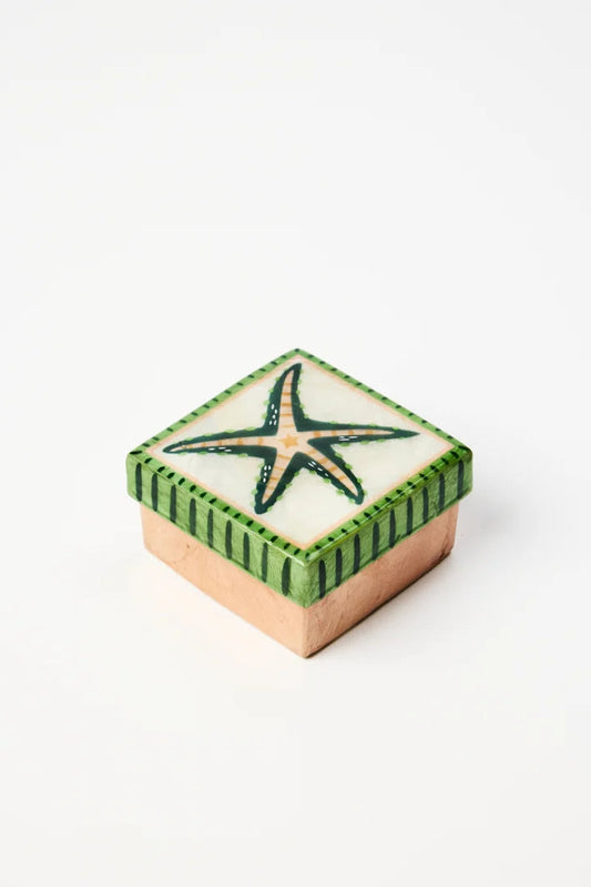 A small square decorative box with a green and white starfish design on top, set against a plain white background.