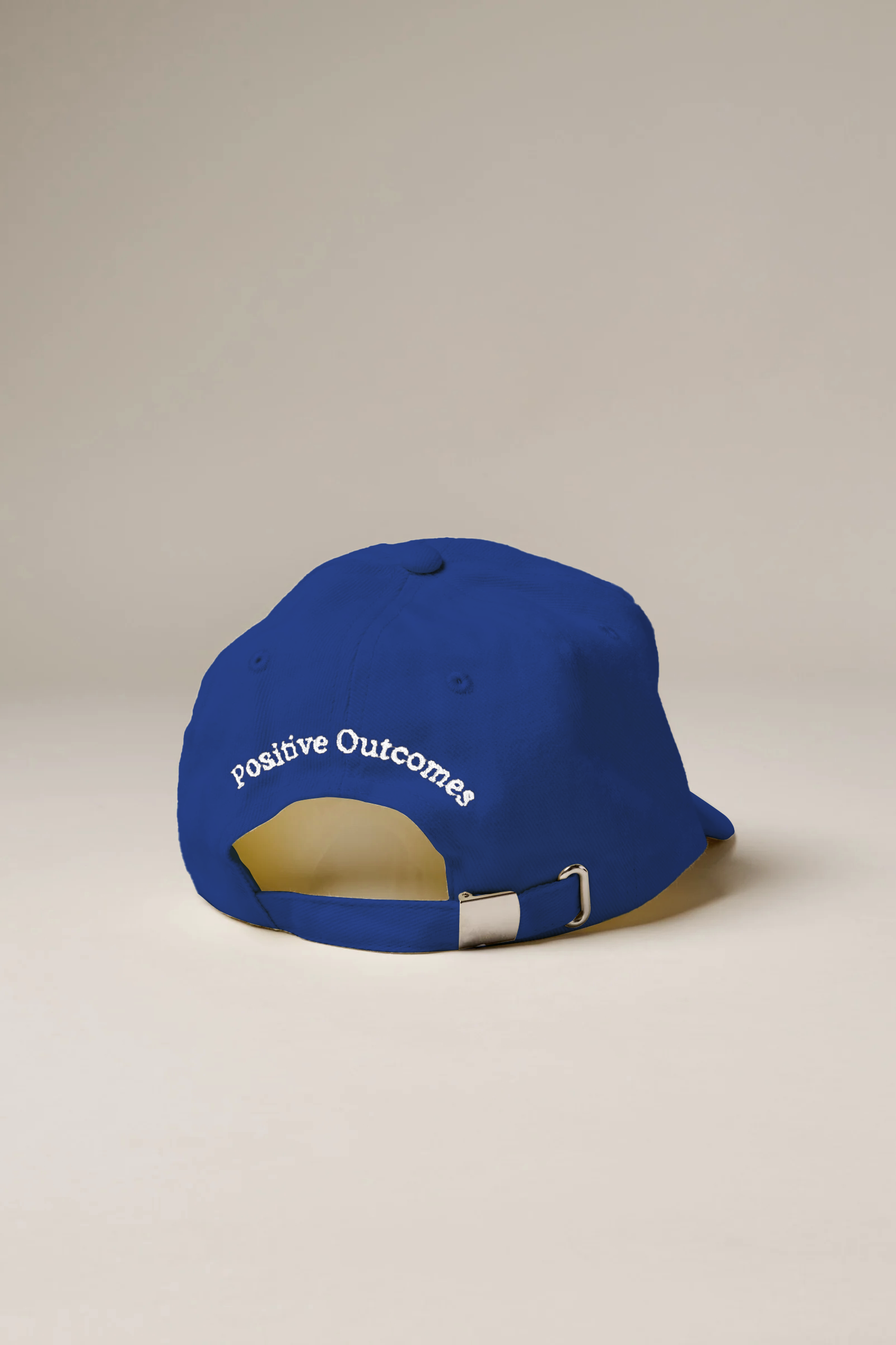 Blue cap with 'Positive Outcomes' text on a beige background