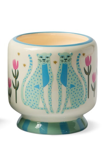 Decorative candle with a matching box featuring cat illustrations on a white background