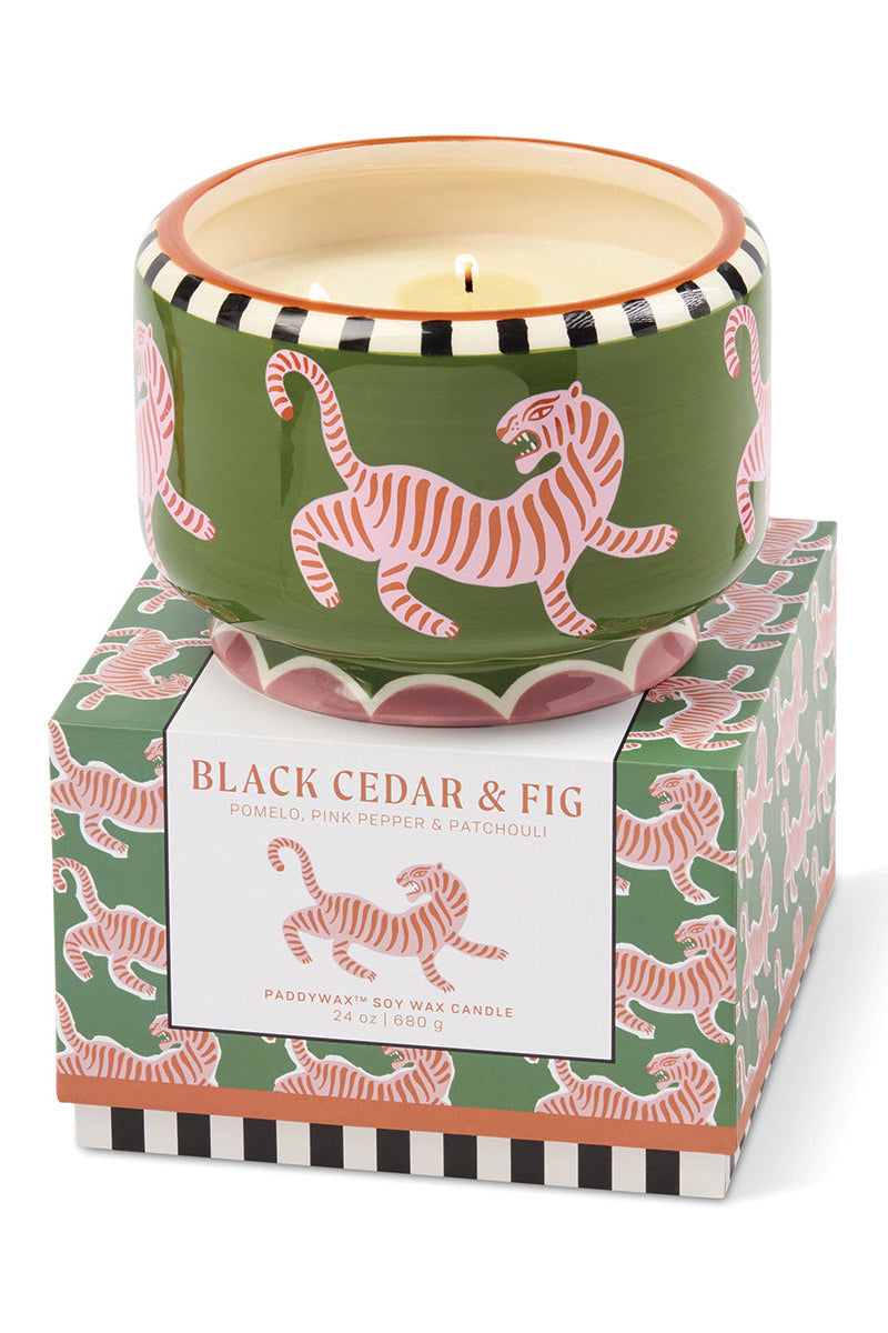 Candle with tiger design packaging on a white background
