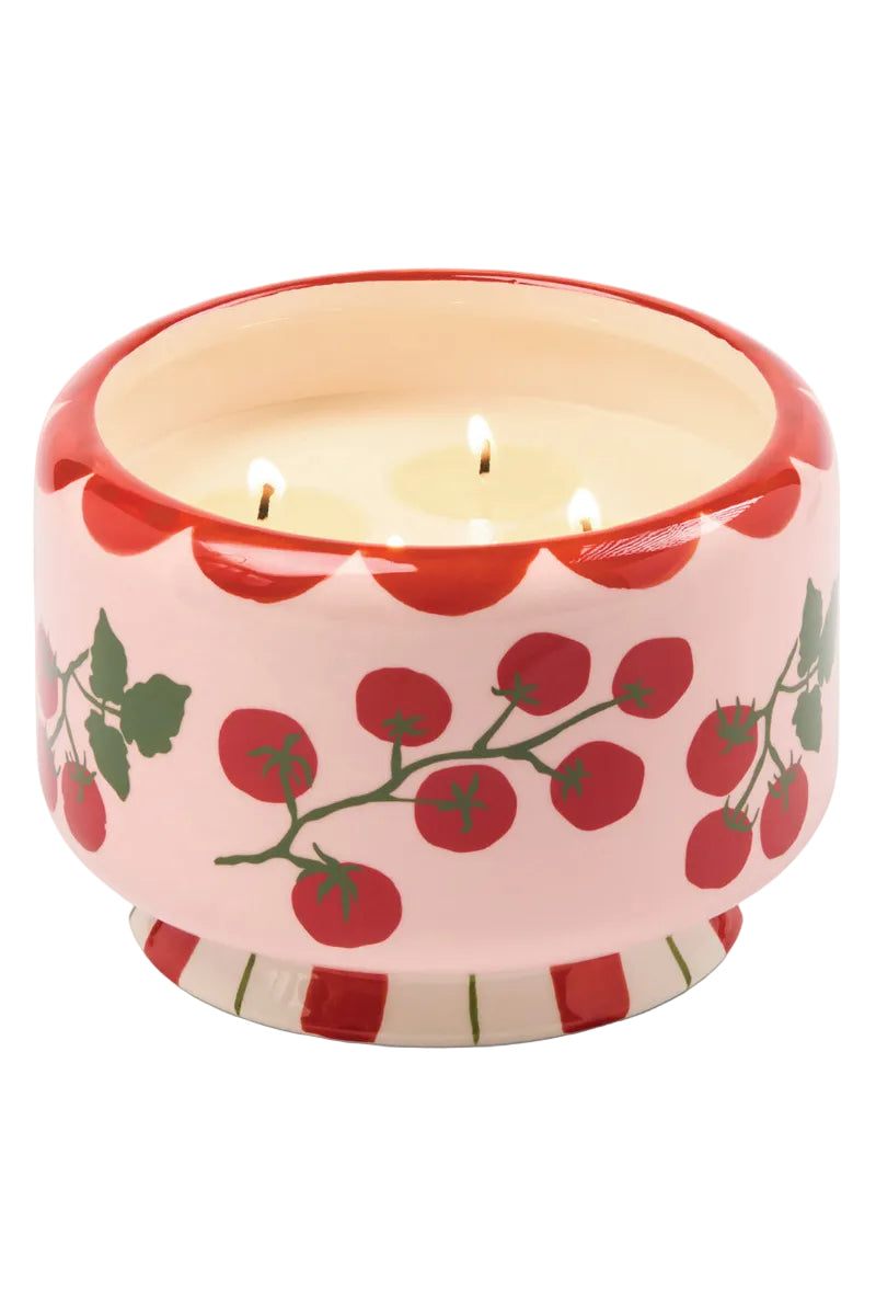 Ceramic candle holder with cherry tomato design on a white background