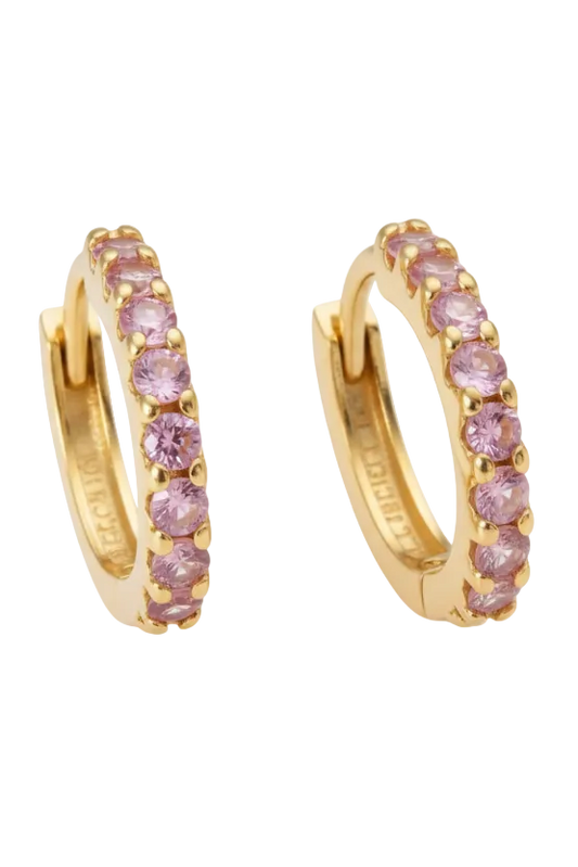 Gold hoop earrings with pink gemstones on a white background