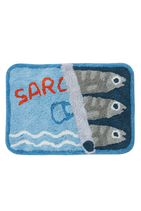 A rectangular tufted bath mat with rounded corners featuring a blue and navy design, three gray fish, white waves, and the partial red text 'SAR' on a white background.