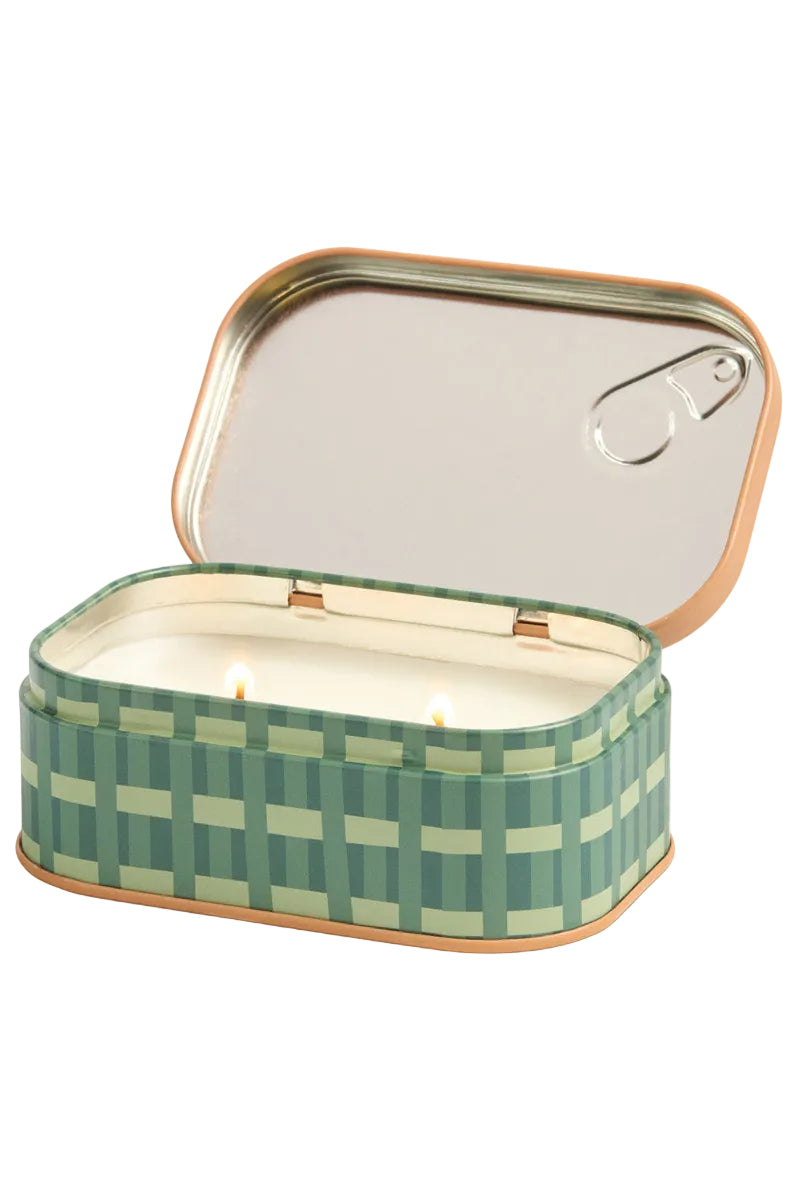 Green checkered candle in a tin with a white background