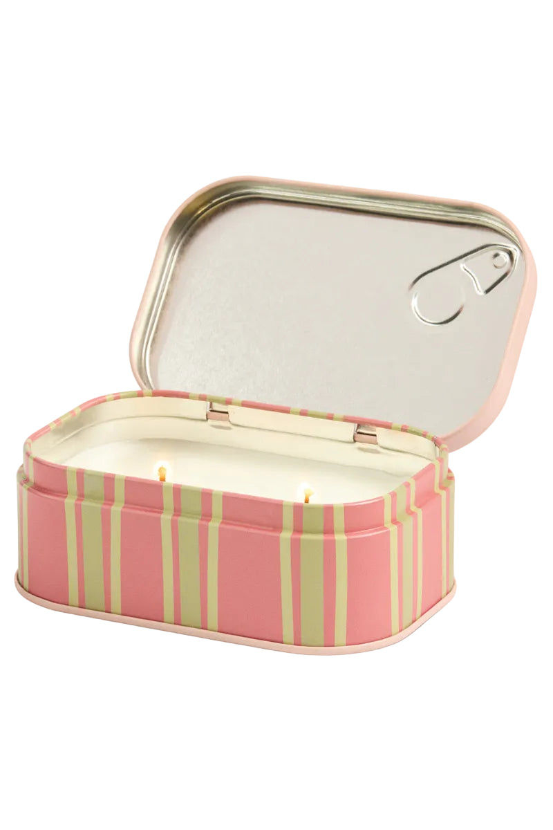 Striped candle in a tin with a lid on a white background