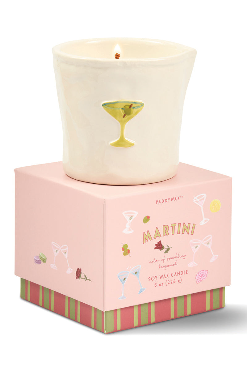 Candle in a decorative pink box with 'Martini' text and cocktail illustrations on a white background.