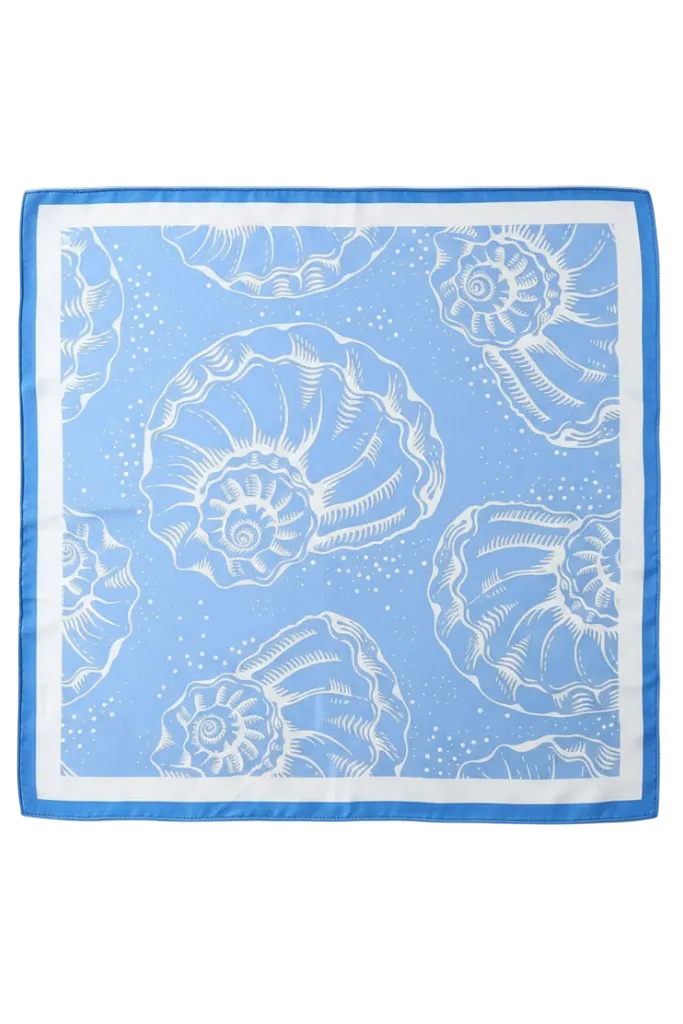 A square silk scarf with a light blue and white nautilus shell pattern, featuring a solid blue border, laid flat against a light gray background.