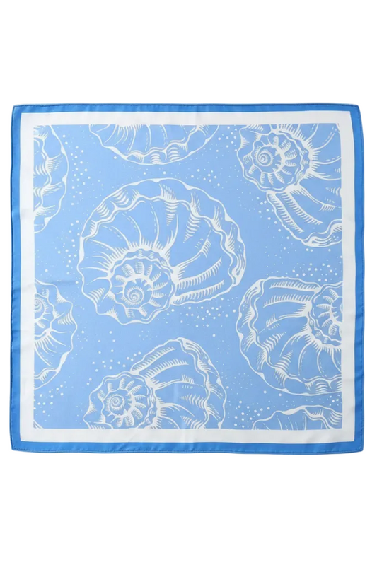 A square silk scarf with a light blue and white nautilus shell pattern, featuring a solid blue border, laid flat against a light gray background.
