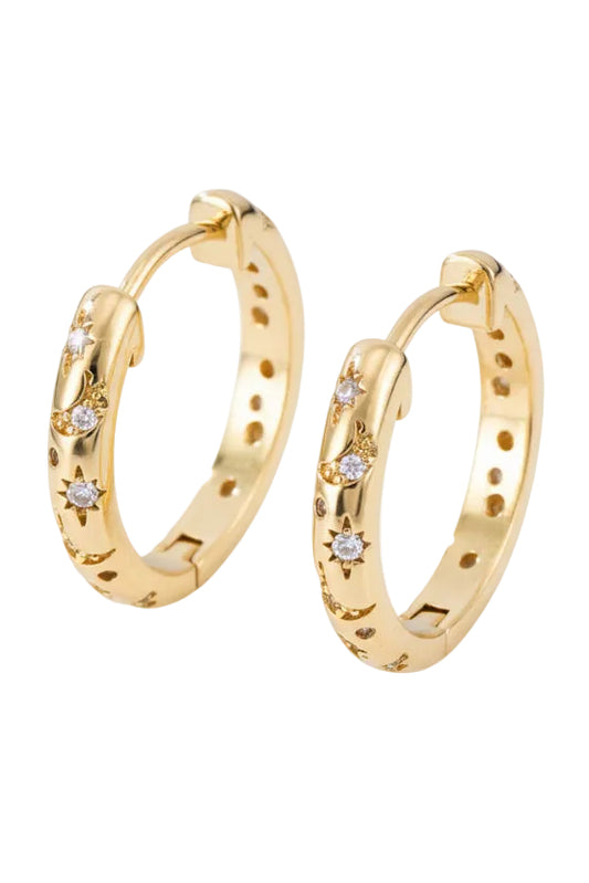 Gold hoop earrings with embedded diamonds on a dark background