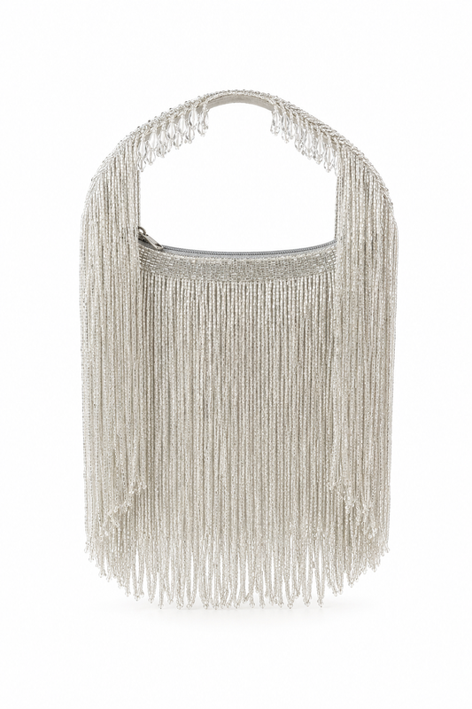 A silver metallic fringe handbag with a curved top handle, photographed against a plain white background.