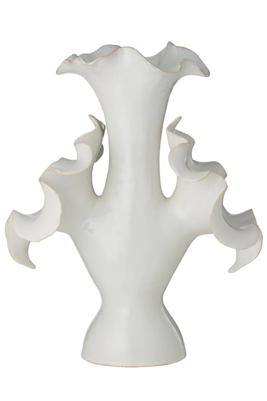 White ceramic vase with wavy design on a white background
