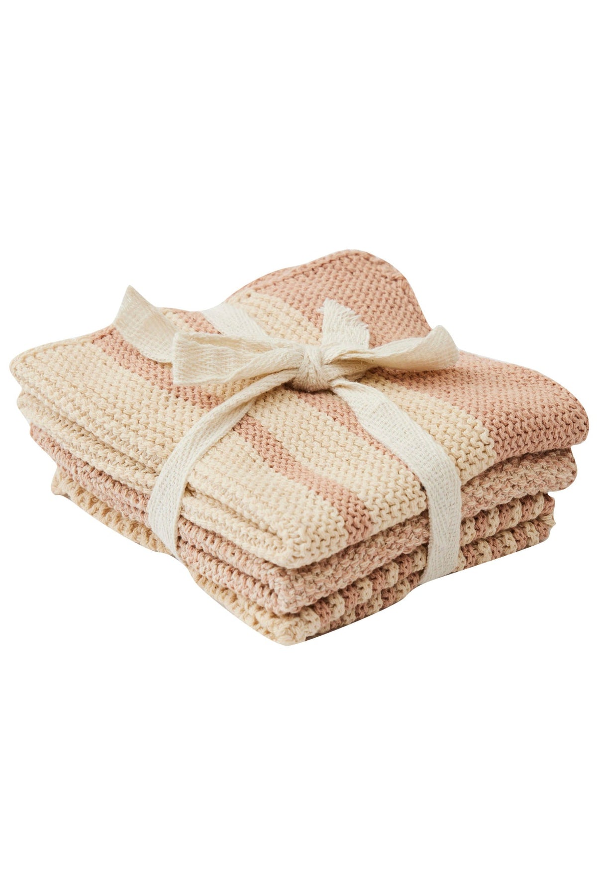 A stack of three folded chunky-knit blankets in a soft striped pattern of cream, beige, and dusty pink, tied with a matching cream ribbon bow on a white background.