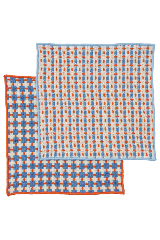 Two patterned cloths with blue and orange checkered design on a white background