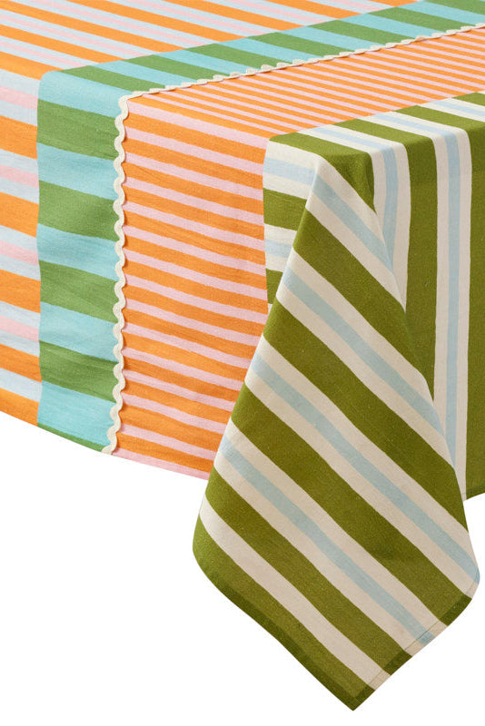 A striped tablecloth shown draped over a table corner, featuring vertical and diagonal stripe patterns in olive green, cream, light blue, and orange.