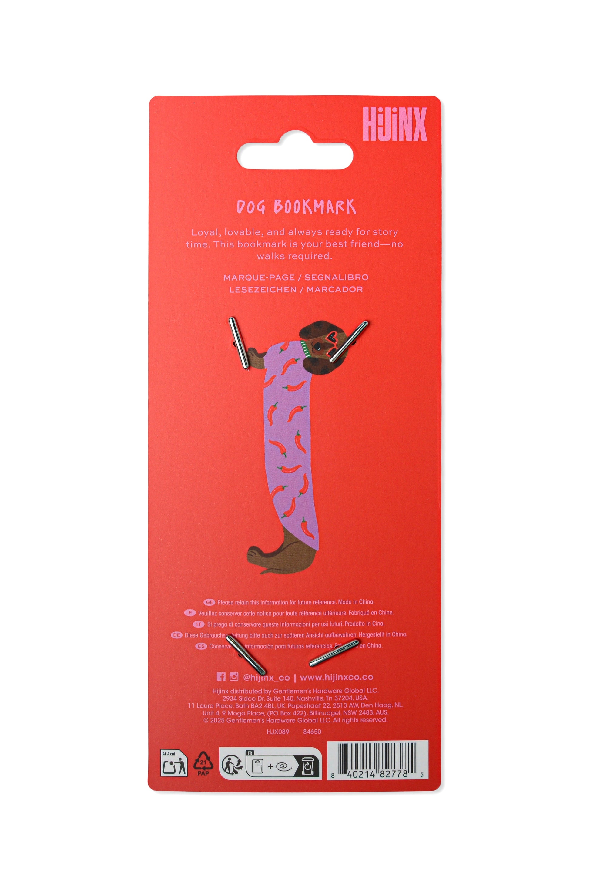 The back of a red retail blister card showing a dog-shaped book mark with text and small product cutouts, photographed on a plain white background.