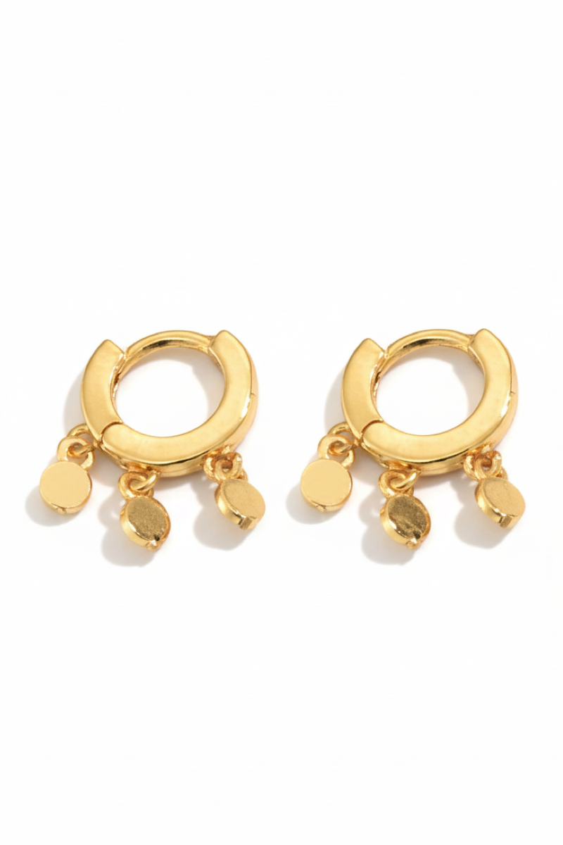 Gold hoop earrings with dangling charms on a white background