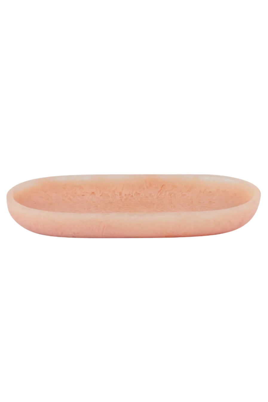 A small, shallow, oval-shaped tray in a soft peach-pink color with a textured, stone-like surface, shown against a plain white background.