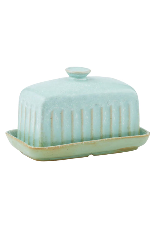 Green ceramic butter dish with lid on a white background