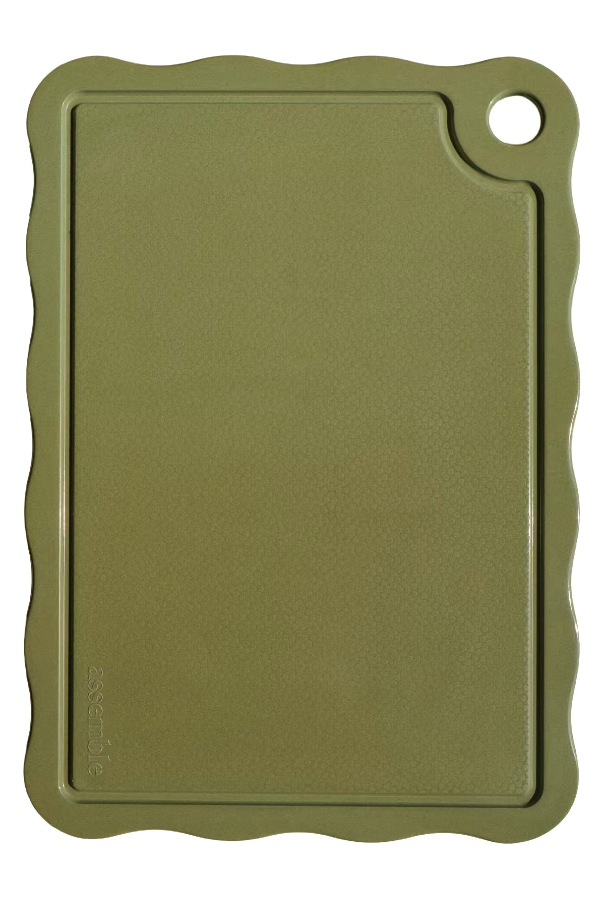 Green cutting board with scalloped edge on a white background