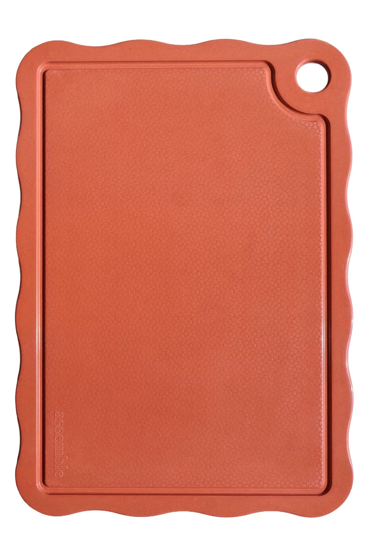 Red cutting board with a handle on a white background