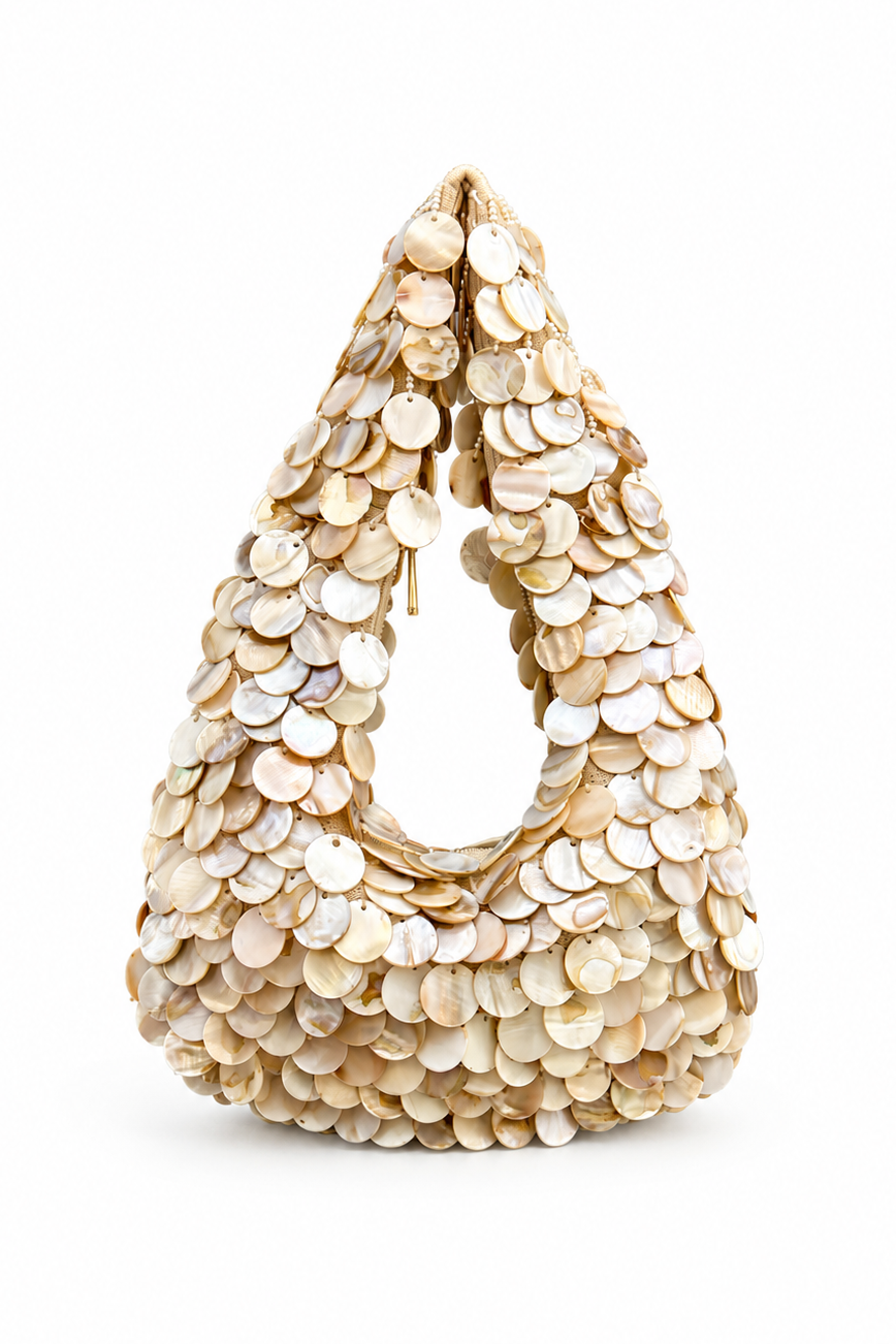 Beige handbag with circular pattern on a white background