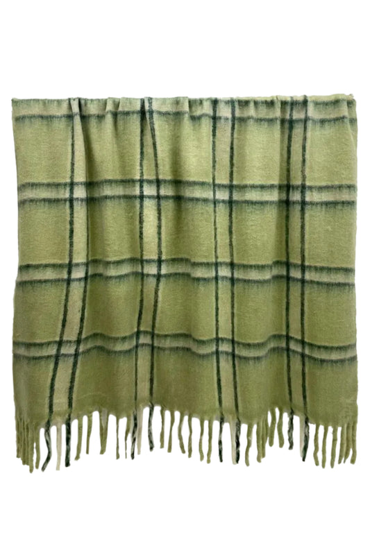 Green plaid blanket with fringe on a white background