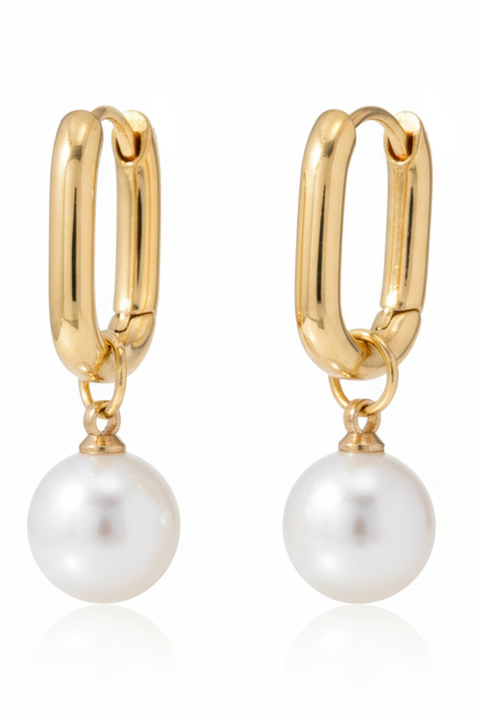 Gold hoop earring with a pearl drop on a white background