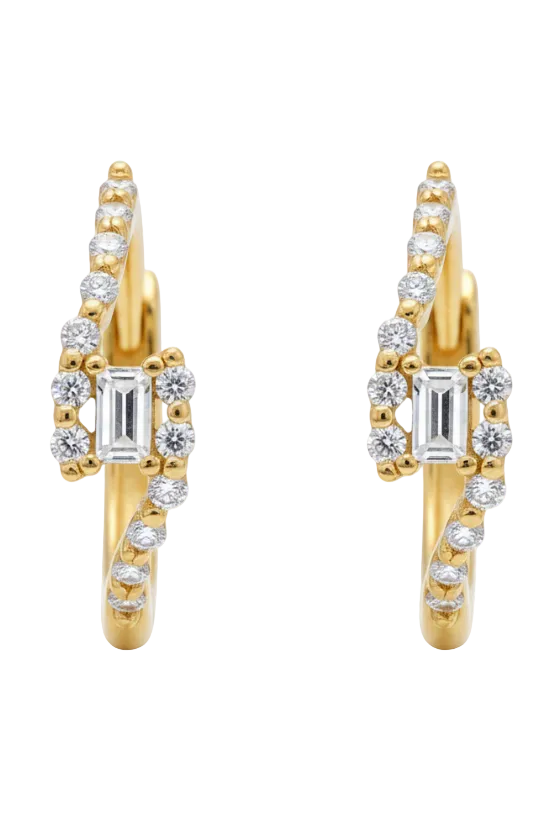 Gold heart-shaped earring with clear gemstones on a light background