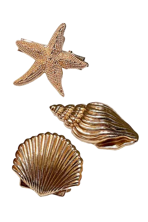 Three gold-toned seashell-shaped accessories on a plain white background: a starfish, a conch shell, and a scallop shell.