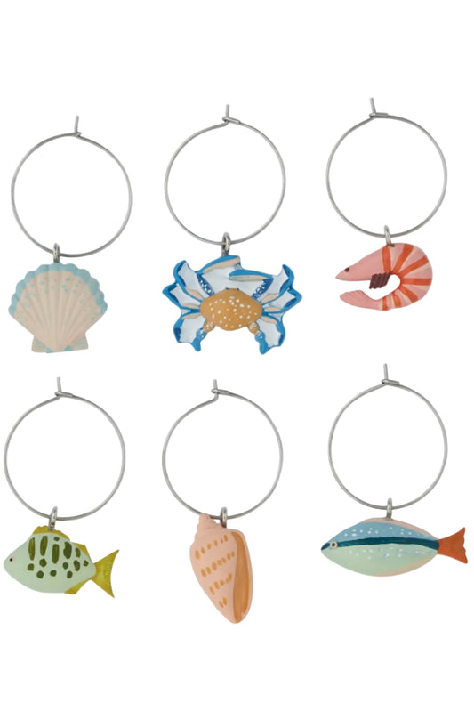 Set of six decorative wine glass charms shaped like sea creatures on a white background
