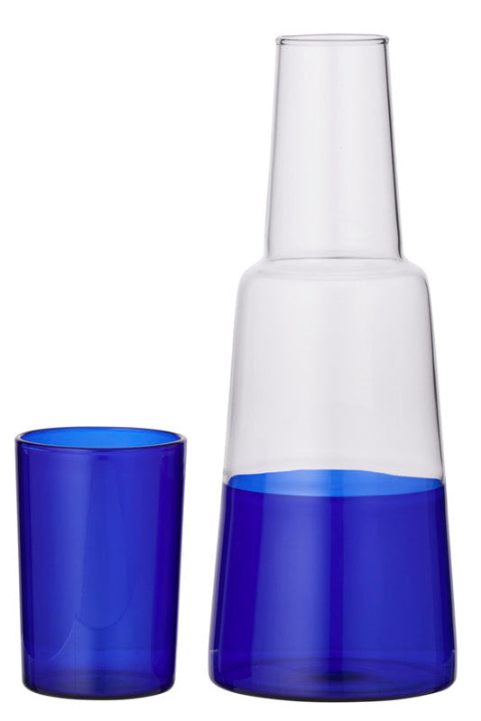 A clear glass carafe with a blue tinted base and a matching cobalt blue tumbler, shown on a plain white background.