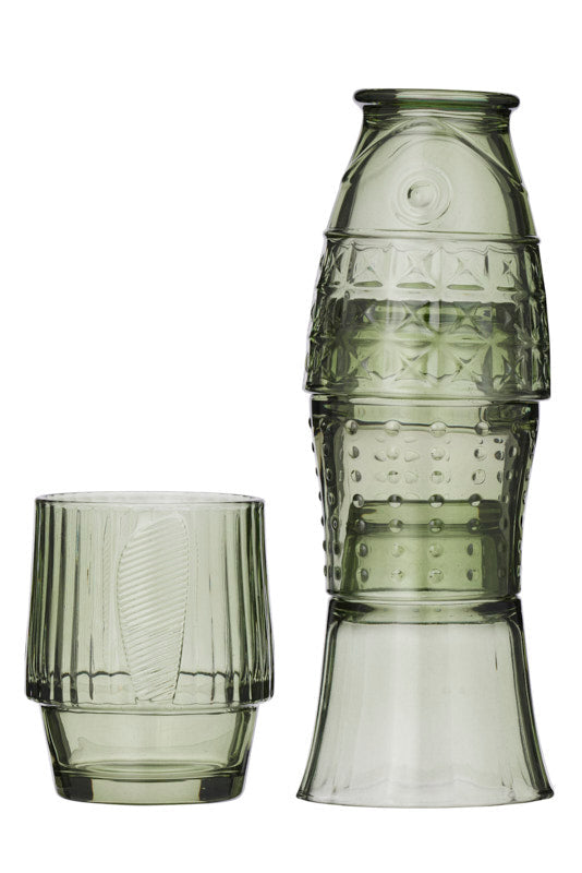 A set of translucent smoky green glassware, featuring 4 short unique shaped tumblers with vertical fluting, set against a plain white background.