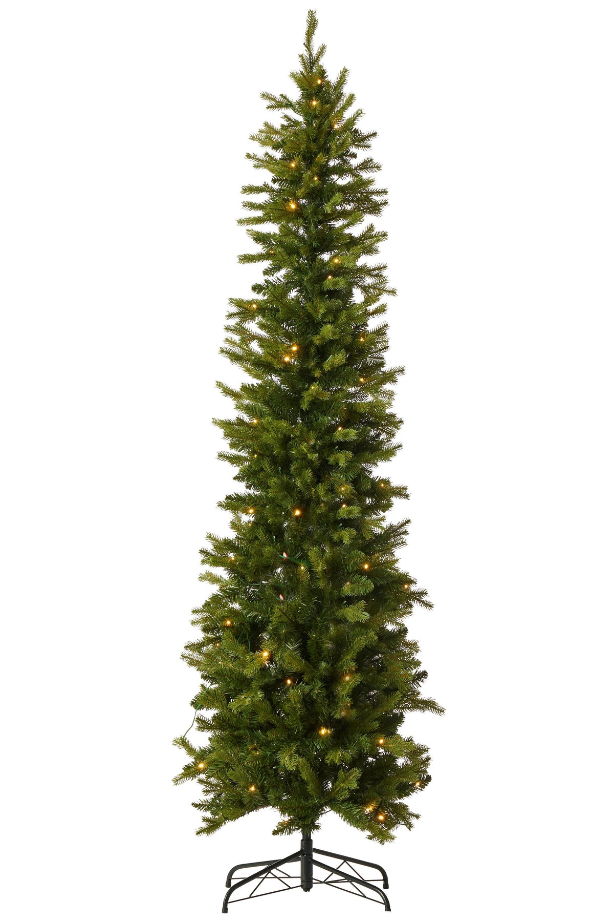 A tall, narrow artificial Christmas tree with dense green needles and warm white string lights, standing on a black metal stand against a plain white background.