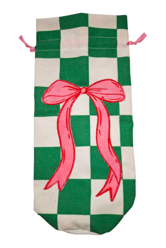 A fabric drawstring pouch featuring a green and cream checkered pattern with a large pink bow graphic in the center and pink drawstring ties.