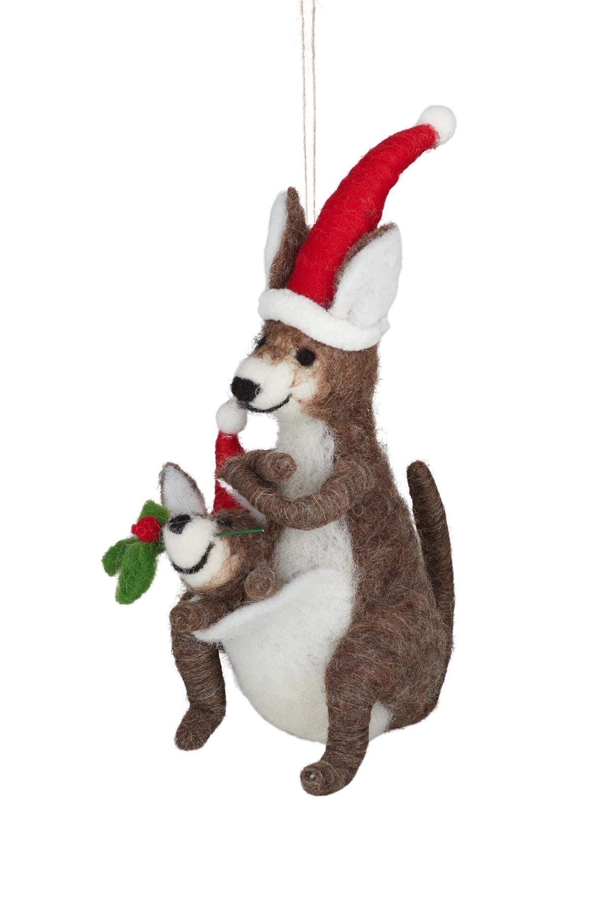 A felt wool kangaroo family Christmas ornament featuring a brown and white mother kangaroo wearing a red Santa hat and holding a small white baby kangaroo with a red Santa hat and green holly sprig, suspended by a string against a white background.