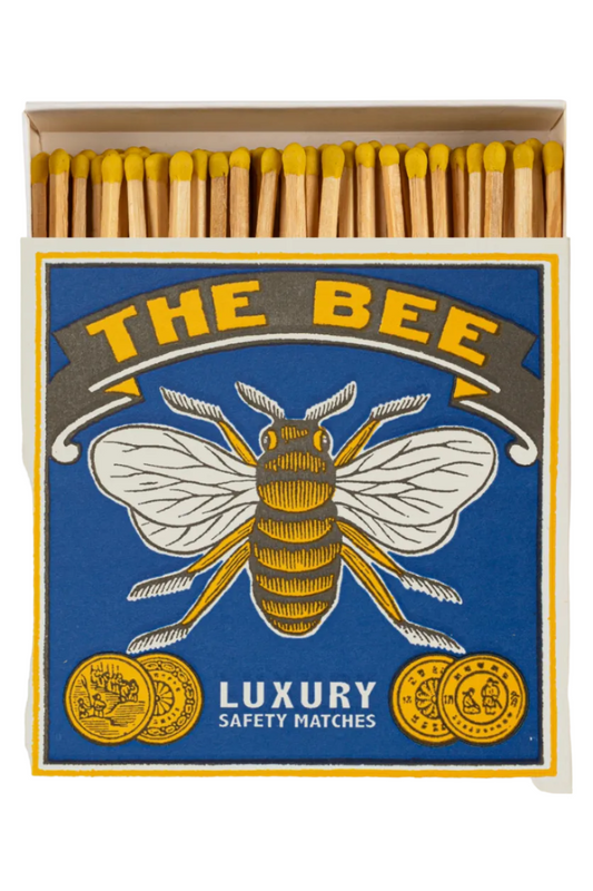 Matchbox labeled 'The Bee' with a bee illustration on a blue background