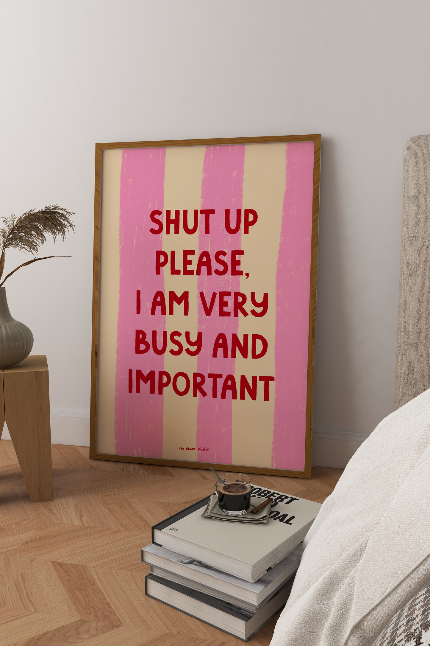 Framed artwork with text in a bedroom setting
