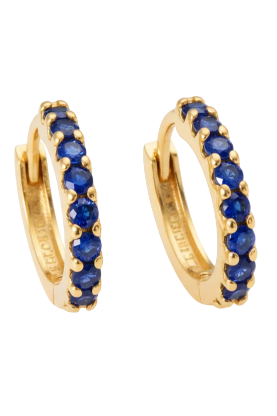 Gold hoop earrings with sapphire stones on a white background