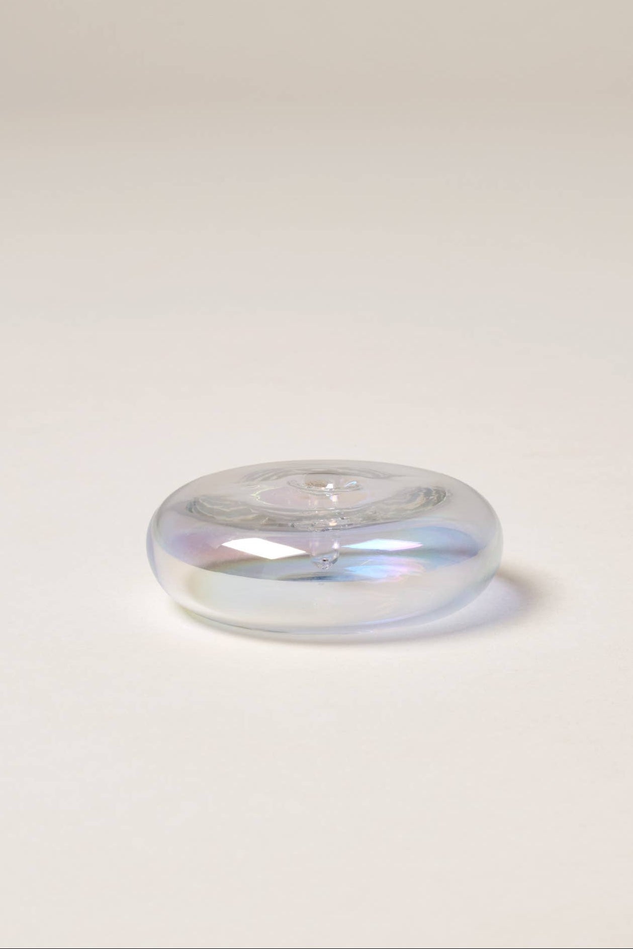 Clear glass object on a light gray background