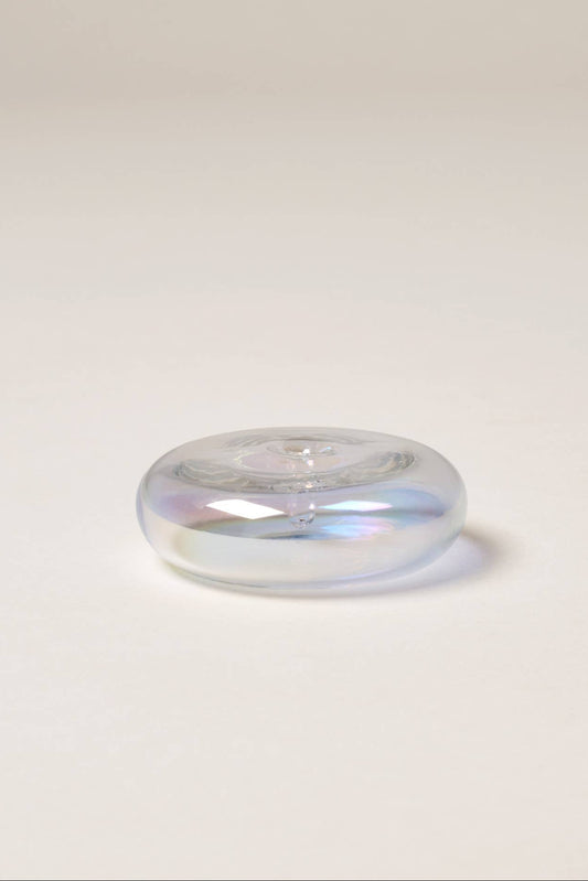 Clear glass object on a light gray background