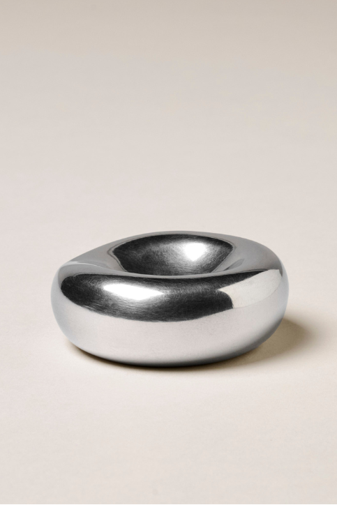 Silver metallic object on a beige background