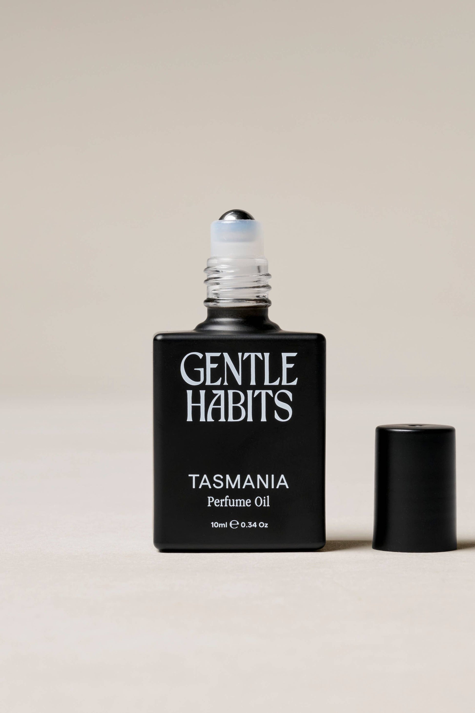 Gentle Habits Tasmania perfume oil bottle on a beige background